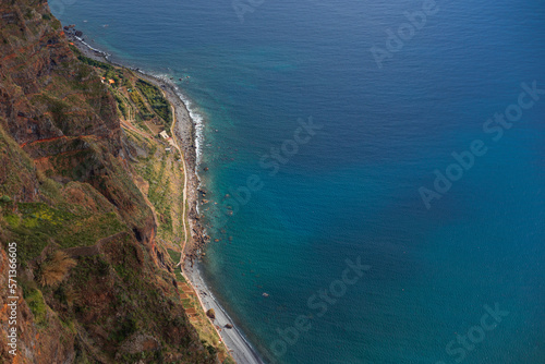 Big beautiful mountain with rock, beach and amazing blue ocean, aerial view. Island of Madeira