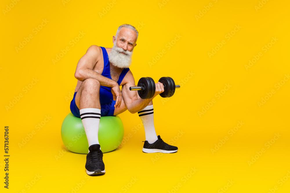 Photo of sporty masculine trainer wear overall lift dumbbells biceps triceps power strength empty space isolated on yellow color background