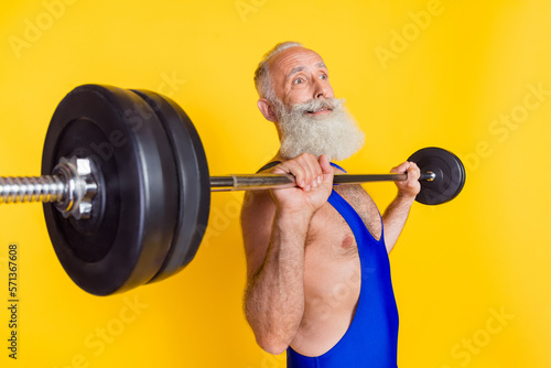 Profile portrait of hardworking sweating person arms hold press barbell isolated on yellow color background