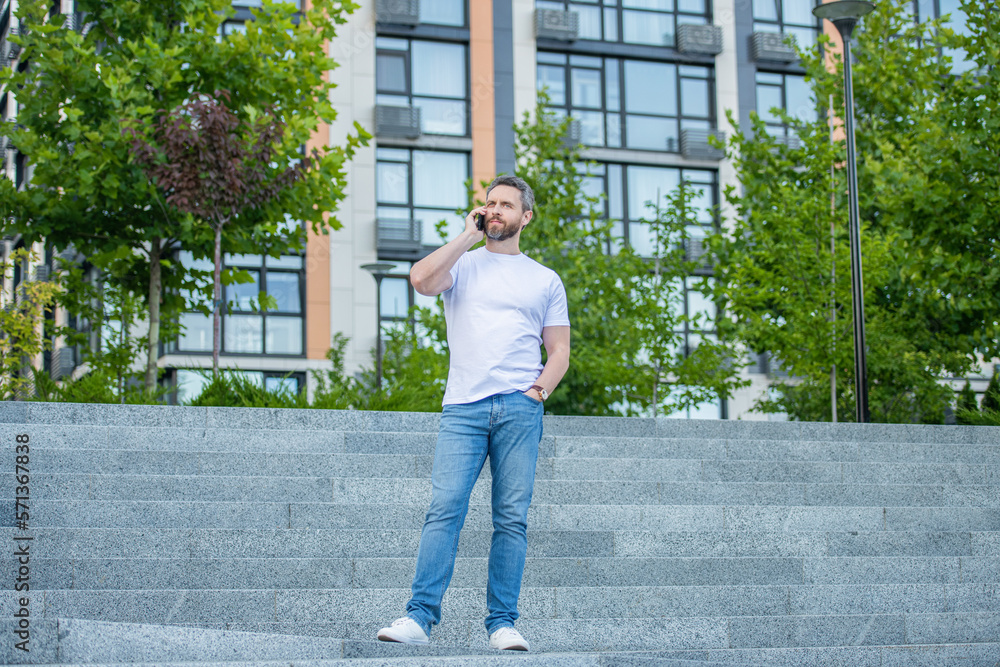 full length of man call on phone outside. photo of man call on phone and talk. full length of man call on phone outside. photo of man call on phone and talk.