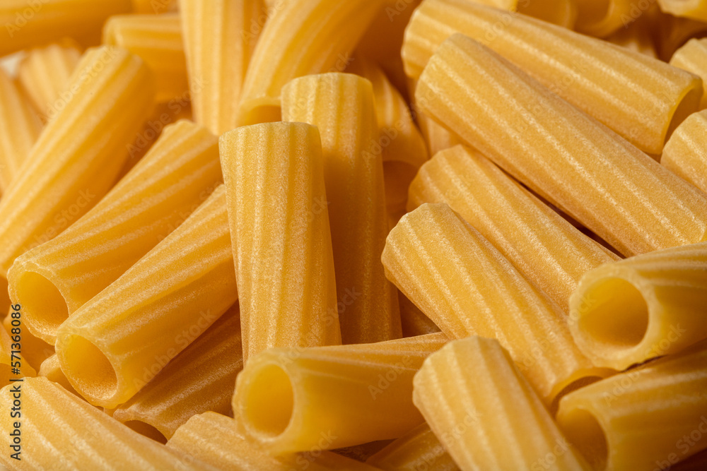 Rigatoni pasta. Uncooked dry noodles. Food background. Rigatoni pasta. Uncooked dry noodles. Food background.