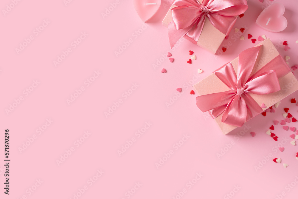 Candy pink lollipops with red gift box on pink background Candy pink lollipops with red gift box on pink background