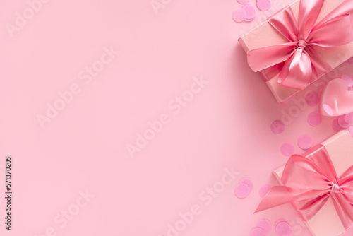 Candy pink lollipops with red gift box on pink background © Denira
