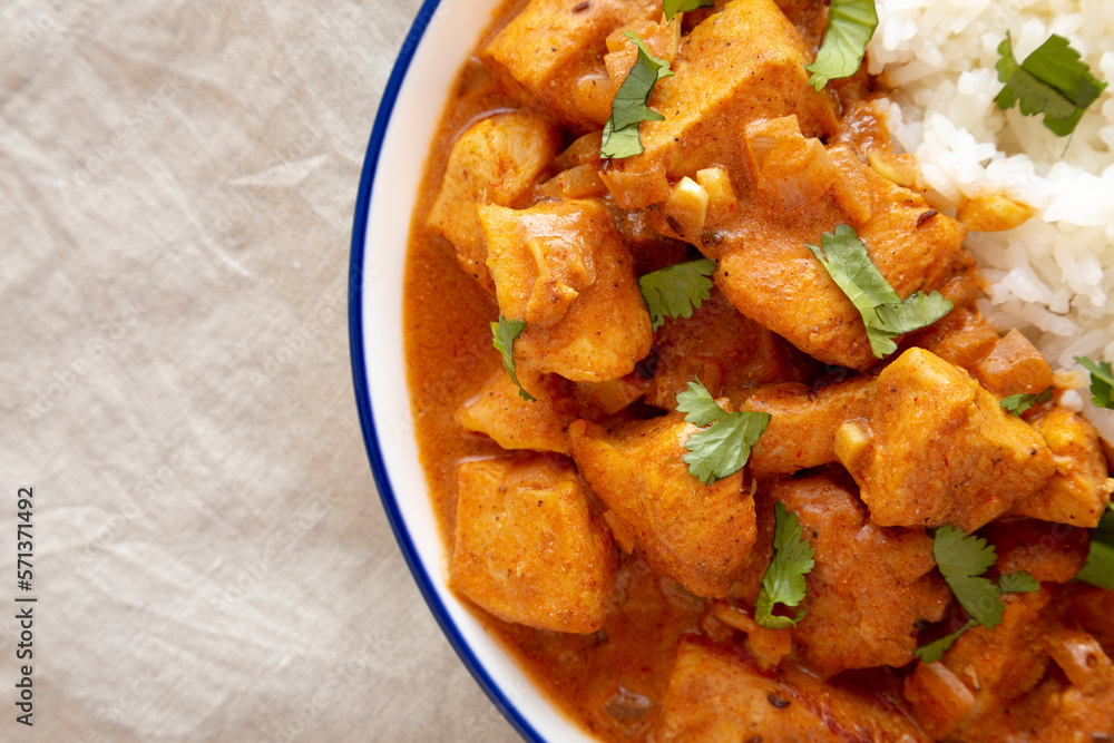 Homemade Easy Indian Butter Chicken with Rice on a Plate, top view. Flat lay, overhead, from above. Copy space. Homemade Easy Indian Butter Chicken with Rice on a Plate, top view. Flat lay, overhead, from above. Copy space.
