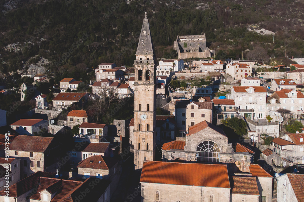 Perast, Montenegro, beautiful aerial top panoramic view of Perast old town with st. Nikola church, with Adriatic sea, bay of Kotor, Dinaric Alps mountains in sunny day