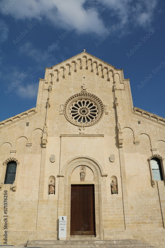 The Cathedral at Piazza Duomo under blue sky in Matera, Italy