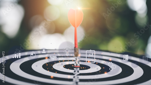 dart arrow hitting in the target center of dartboard,Business targeting and focus concept,the growth and purpose of the organization,Competitive marketing strategy planning management