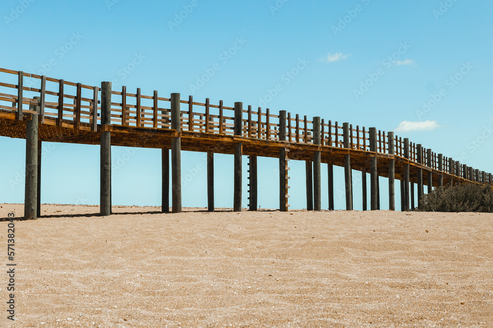 Large wooden bridge background with a field of sand in the beach from puerto rico isabela west side