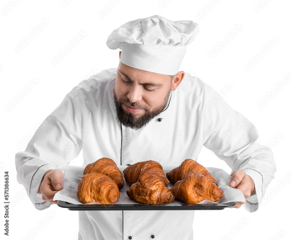 Male baker with tray of tasty croissants on white background Male baker with tray of tasty croissants on white background