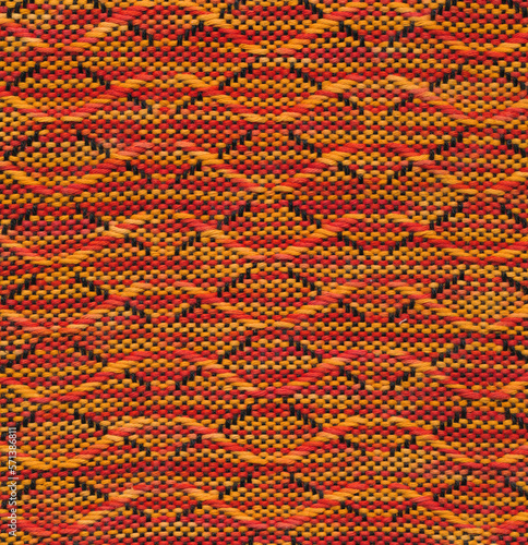 Handwoven wavy pattern in black, orange and red.