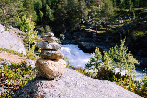 A cairn on a raging river photo