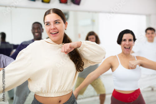 Group of multinational people practicing new modern dance techniques at a dance school during a lesson