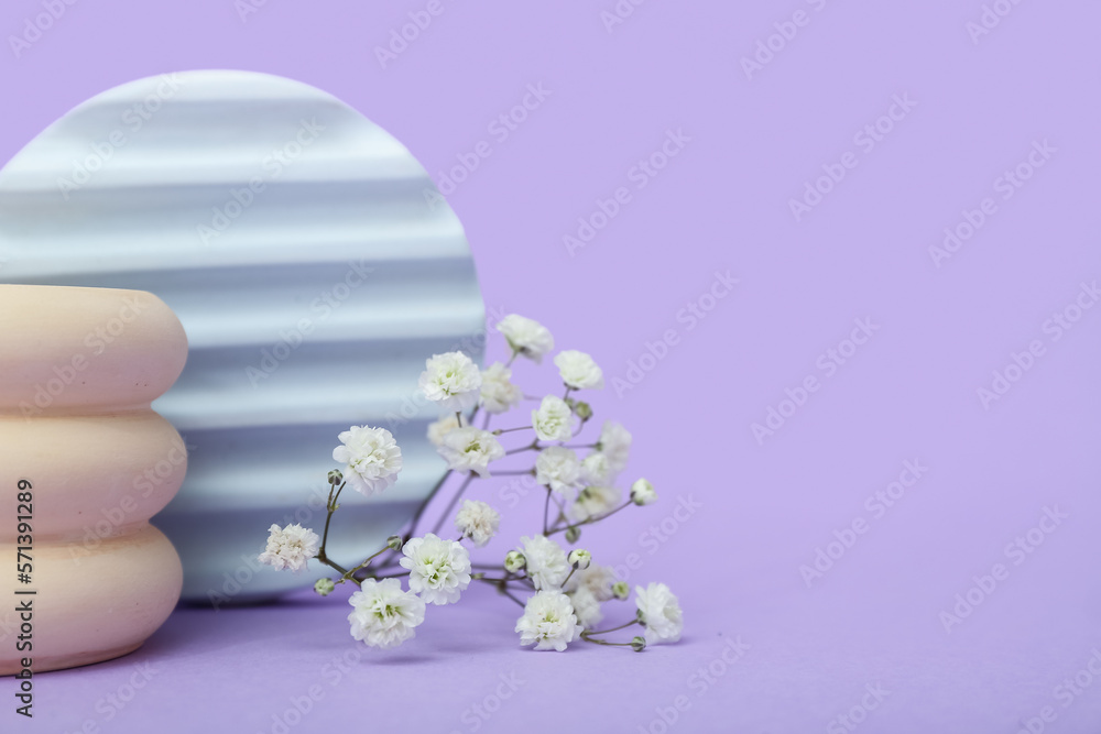 Podiums with beautiful gypsophila flowers on lilac background. Hello spring