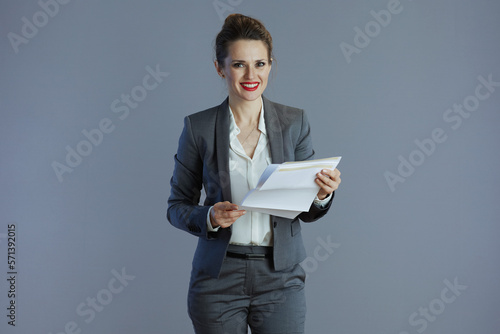 happy 40 years old business owner woman isolated on gray