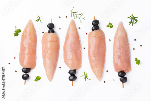 Raw chicken inner on skewers with olives with spices,herbs on white background.Uncooked Chicken meat,kebab on skewers.Skewers of raw meat and vegetables.Top view.Chicken Skewers breast fillet meat. photo