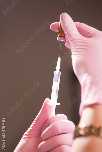 Medic holding a syringe for injection isolated.