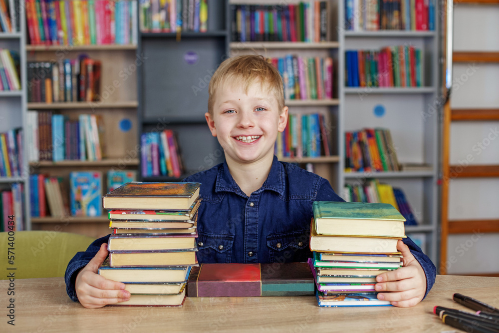 Child boy reads book from bookshelves in library. Bookstore concept, education and knowledge. Child boy reads book from bookshelves in library. Bookstore concept, education and knowledge.