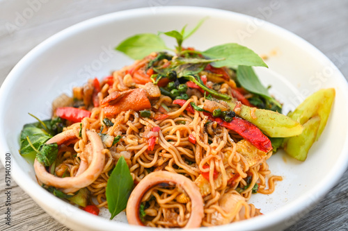 noodles plate with instant noodles stir fried with vegetables herb spicy tasty appetizing asian noodles mix seafood stir fried squid with basil and chilli pepper © Bigc Studio