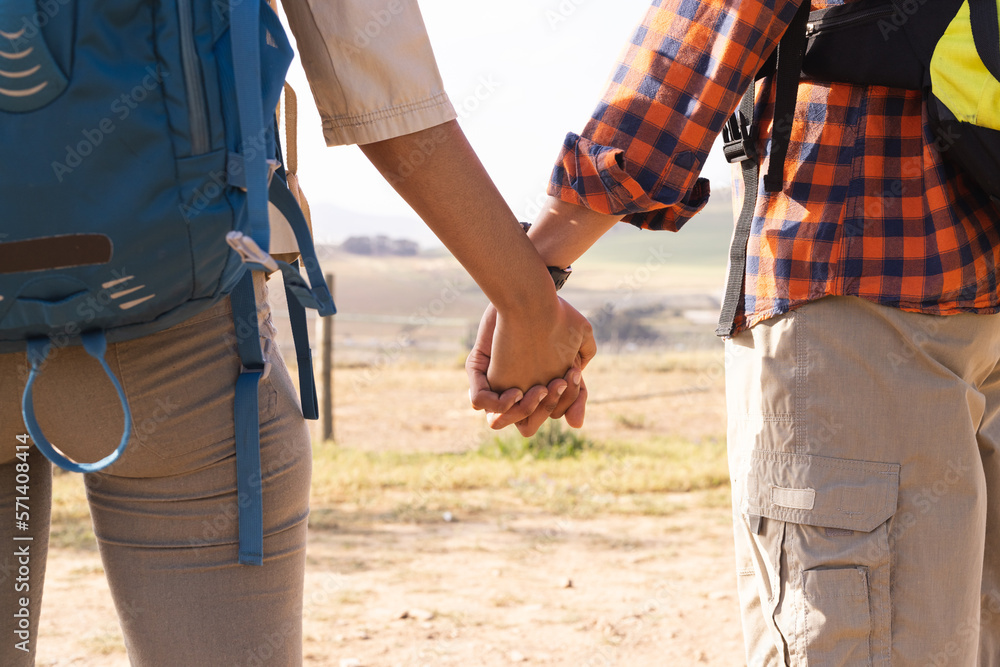 Close up of african american couple holding hands on sunny day in countryside Close up of african american couple holding hands on sunny day in countryside