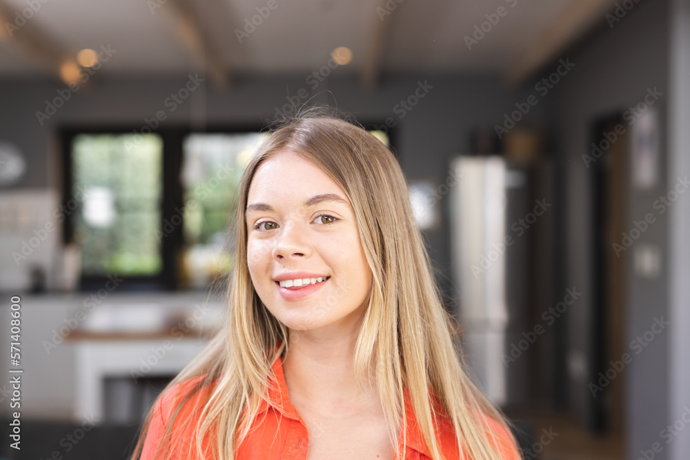 Portrait of happy caucasian teenage girl smiling in kitchen Portrait of happy caucasian teenage girl smiling in kitchen