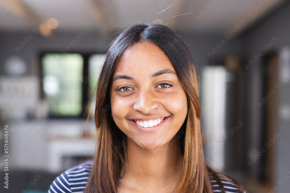 Portrait of happy biracial teenage girl smiling in kitchen Portrait of happy biracial teenage girl smiling in kitchen