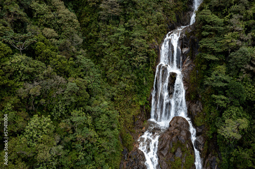 Aerial high angle view, approaching a large waterfall near Banos de Agua Santa in Ecuador, South America