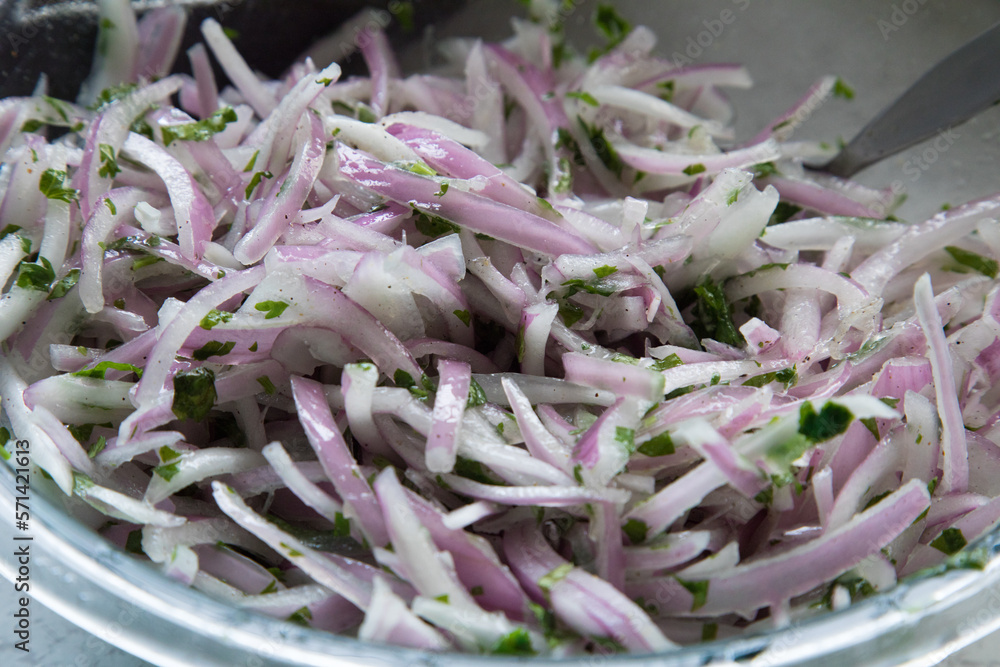 Red onion chopped in thin slices for meal preparation peruvian food zarza criolla Red onion chopped in thin slices for meal preparation peruvian food zarza criolla