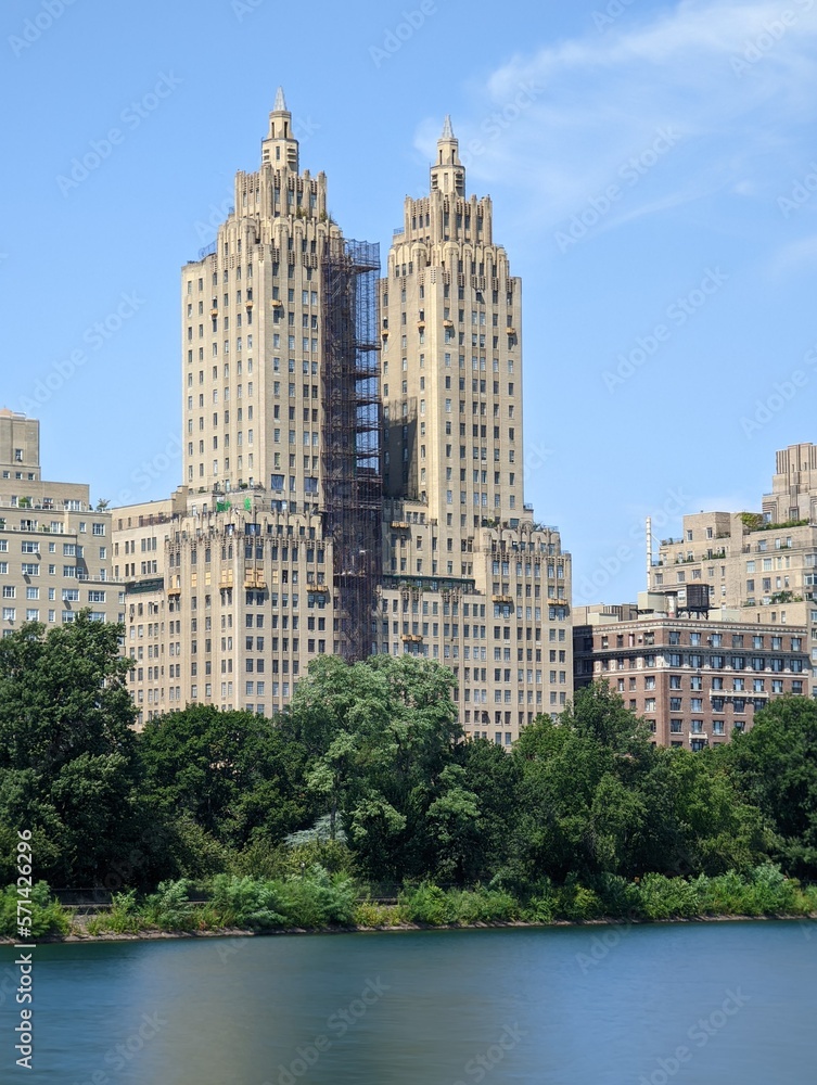 long exposure photo of a view of the city towers from the river from the central park  in a day of spring, manhattan island, new york city nature plants and outdoors 