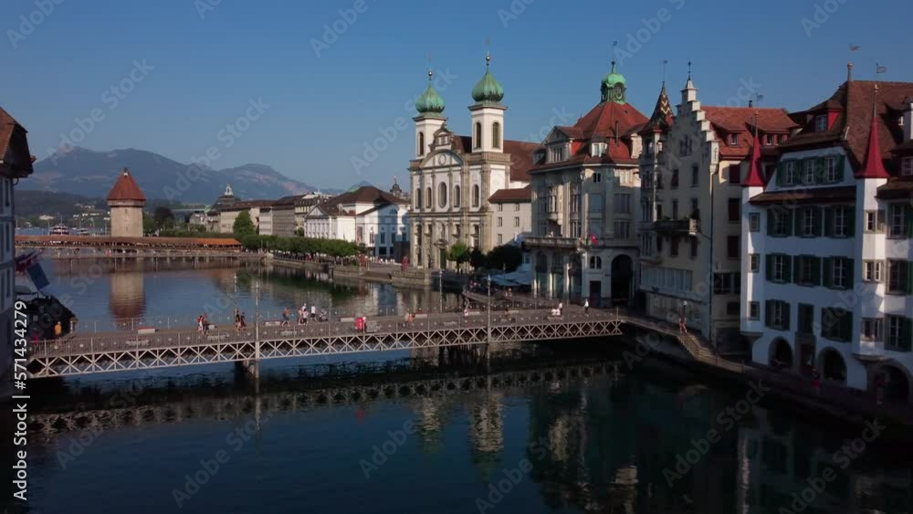 Low flight over the hisoric center of Lucern on the shores of river Reuss. Showing, famous Jesutitenkirhce, and Kapellbrücke Low flight over the hisoric center of Lucern on the shores of river Reuss. Showing, famous Jesutitenkirhce, and Kapellbrücke