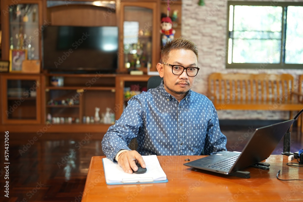 middle-aged man sitting at a desk in the office middle-aged man sitting at a desk in the office