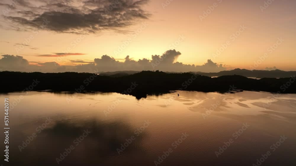 A serene sunset silhouettes tropical scenery in the Solomon Islands. This beautiful Melanesian country is home to extraordinary marine biodiversity and many historic WWII sites. A serene sunset silhouettes tropical scenery in the Solomon Islands. This beautiful Melanesian country is home to extraordinary marine biodiversity and many historic WWII sites.