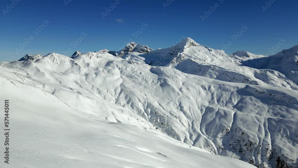 The mountain panorama of the snow-covered ski resort Rosswald in winter. Snowy mountain peaks. Aerial Shot The mountain panorama of the snow-covered ski resort Rosswald in winter. Snowy mountain peaks. Aerial Shot