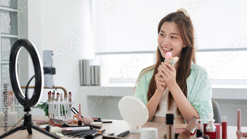 Beauty blogger concept, Young woman presenting different makeup brush and introduce product on Vlog