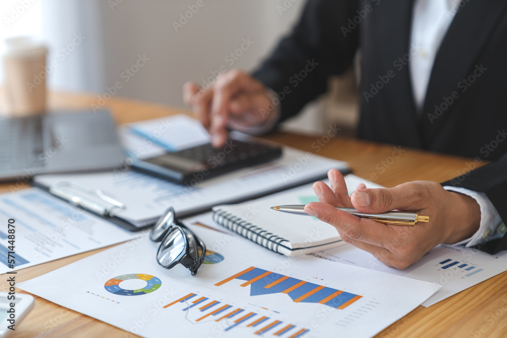 Asian business woman Calculate turnover with calculator. Take note. Have notepad to remember to do financial report or profit. Income tax. Idea concept. Accounting. Finance. Asian business woman Calculate turnover with calculator. Take note. Have notepad to remember to do financial report or profit. Income tax. Idea concept. Accounting. Finance.