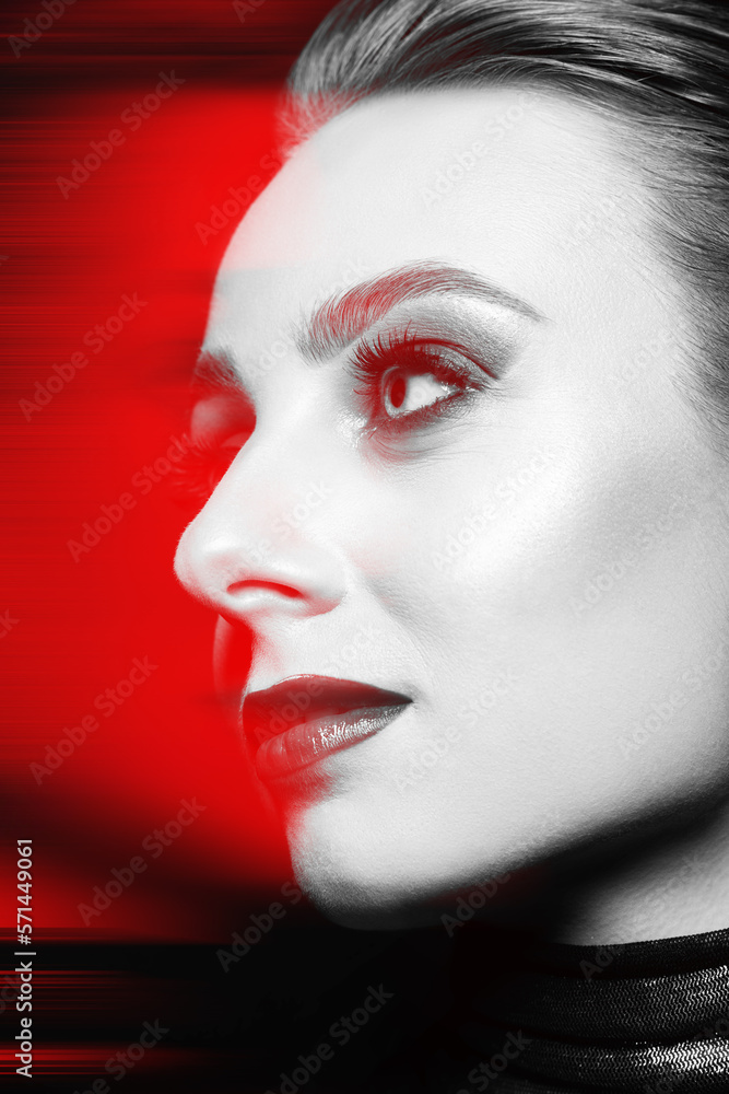 Studio portrait of beautiful woman with fancy evening make-up in red color split effect. Model with eyes looking aside the camera with seductive look. Futuristic looking style Studio portrait of beautiful woman with fancy evening make-up in red color split effect. Model with eyes looking aside the camera with seductive look. Futuristic looking style