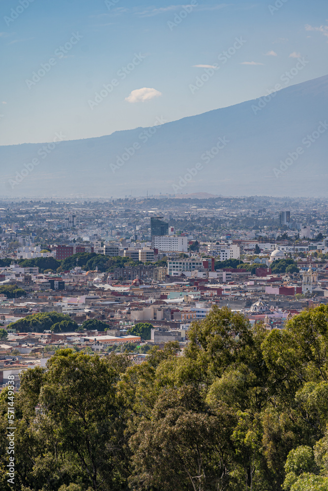 Beautiful view of the large Mexican city of Puebla. View of the endless mountain peaks around the city.