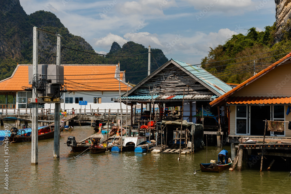 Fototapeta premium Phang Nga, Thailand - January 22, 2023: Fishing boats along the houses in the floating village of Koh Panyi