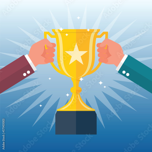 Two people are holding up a winning trophy together