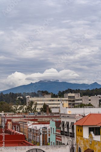 Beautiful view of the large Mexican city of Puebla. View of the endless mountain peaks around the city. © nikwaller