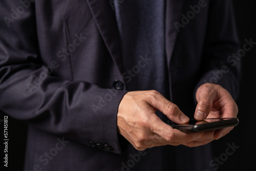 Close up of business man hand using mobile phone, searching the information during online working , internet networking, business planning, social media marketing