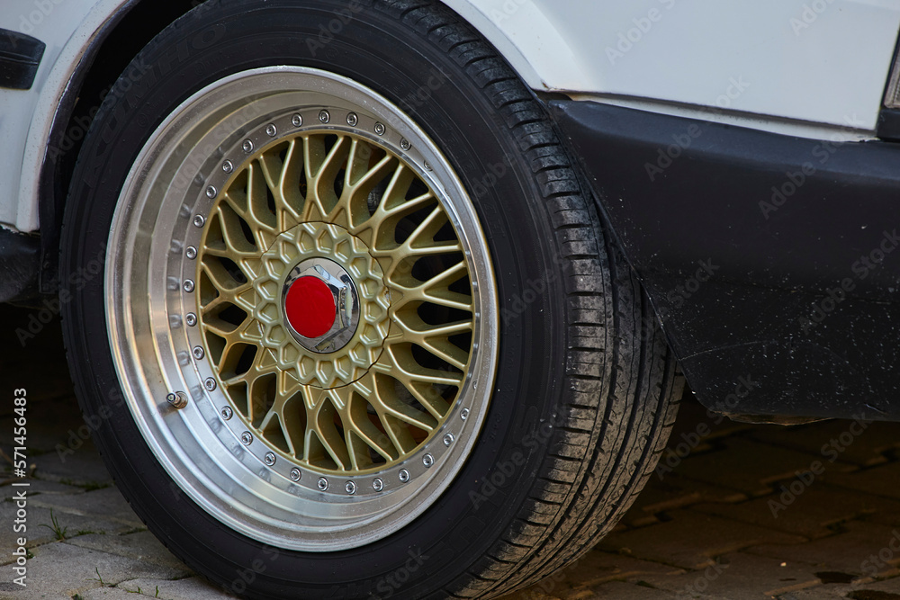 Car wheel on an old wheel rusted car