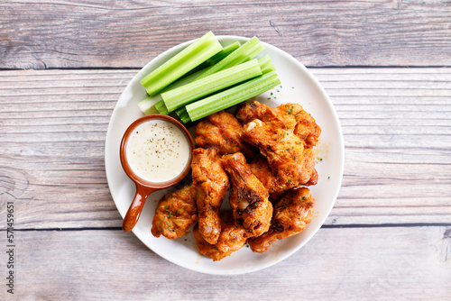 Barbecue chicken wings on a white plate.