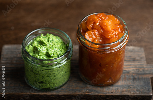 Traditional Indian chutneys in glass jars, selective focus