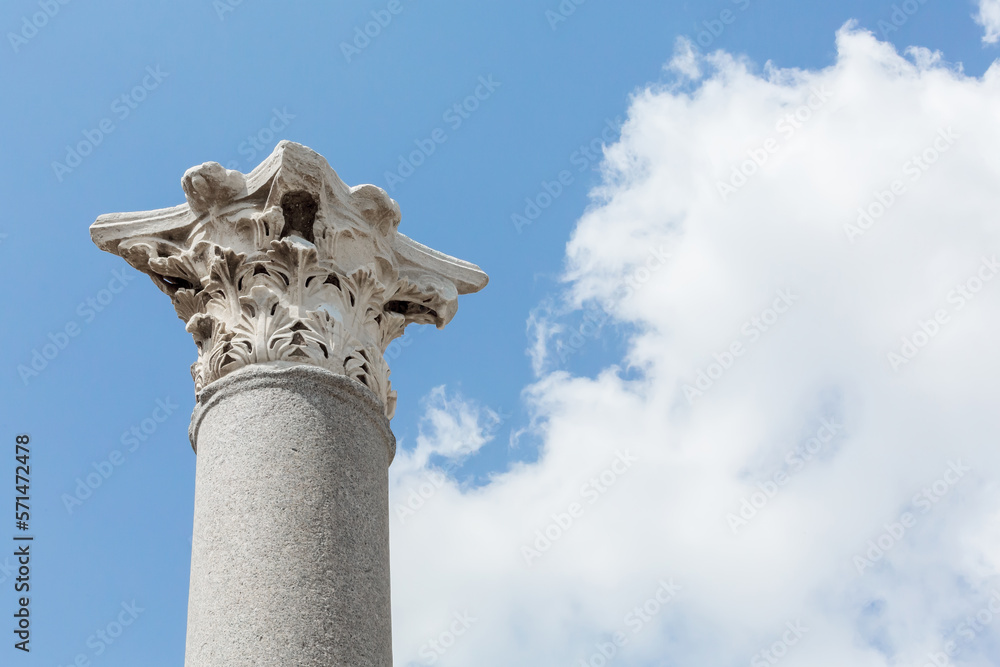 Corinthian capital (partially ruined) and columns in Perge (Perga), ancient Anatolian city. Blue sky at background. Copy space. Design or art history concept. Antalya region, Turkey (Turkiye)