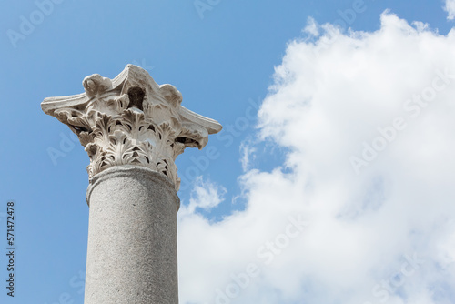 Corinthian capital (partially ruined) and columns in Perge (Perga), ancient Anatolian city. Blue sky at background. Copy space. Design or art history concept. Antalya region, Turkey (Turkiye)