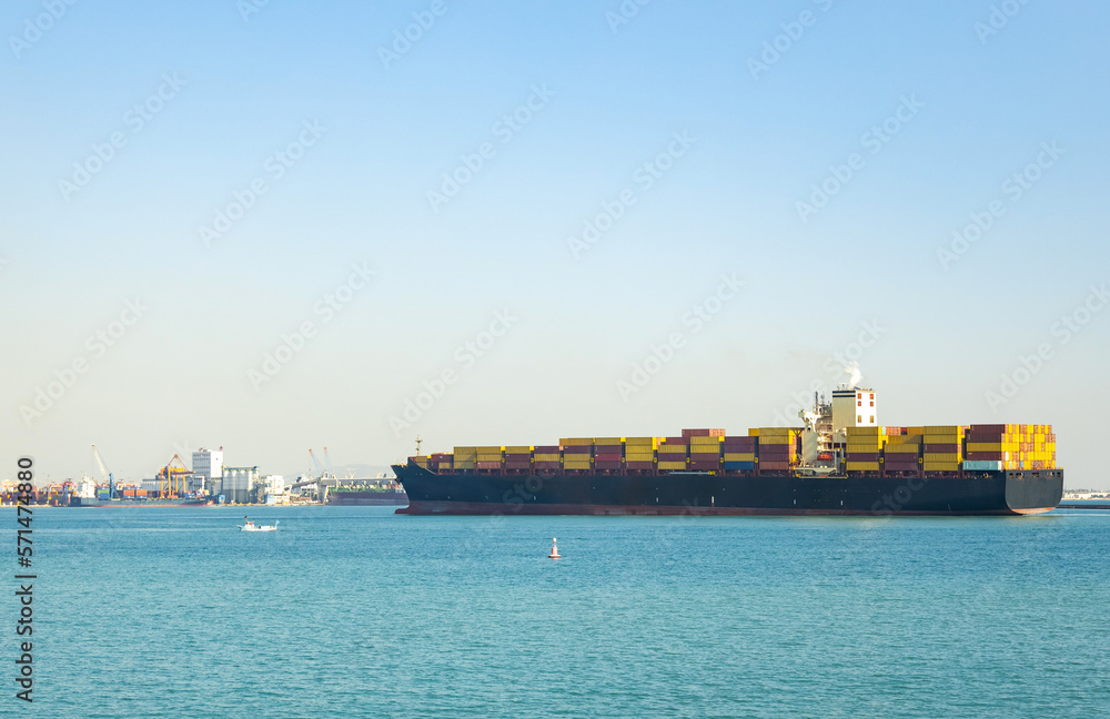 Large cargo container ship sails in the seaport