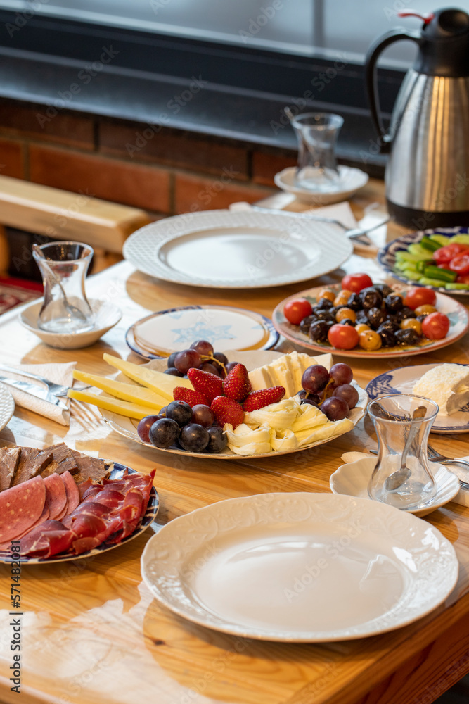 Ramadan table. The sahur table with cheese varieties, salami, pastrami, roasting, olives and tea Ramadan table. The sahur table with cheese varieties, salami, pastrami, roasting, olives and tea