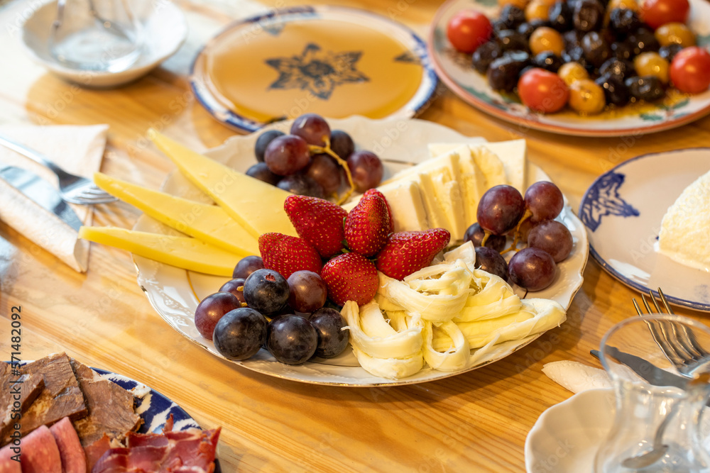 Ramadan table. The sahur table with cheese varieties, salami, pastrami, roasting, olives and tea Ramadan table. The sahur table with cheese varieties, salami, pastrami, roasting, olives and tea
