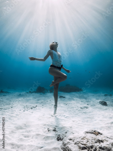 Wallpaper Mural Freediver girl posing underwater. Free diving with woman in blue ocean with sandy bottom and sun rays Torontodigital.ca
