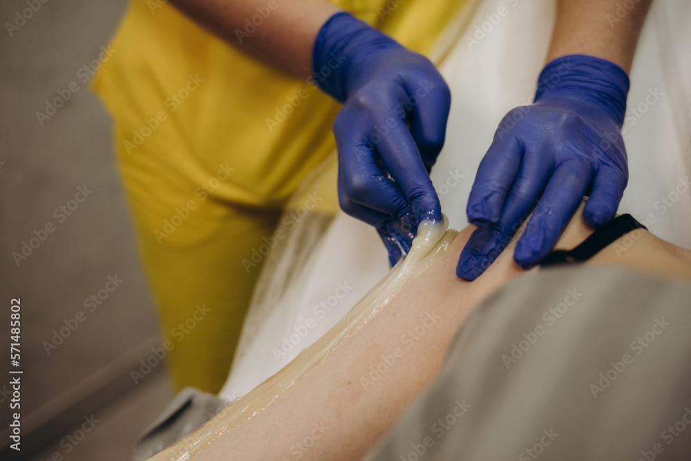 process paraffin treatment of female hands in a beauty salon. process paraffin treatment of female hands in a beauty salon.
